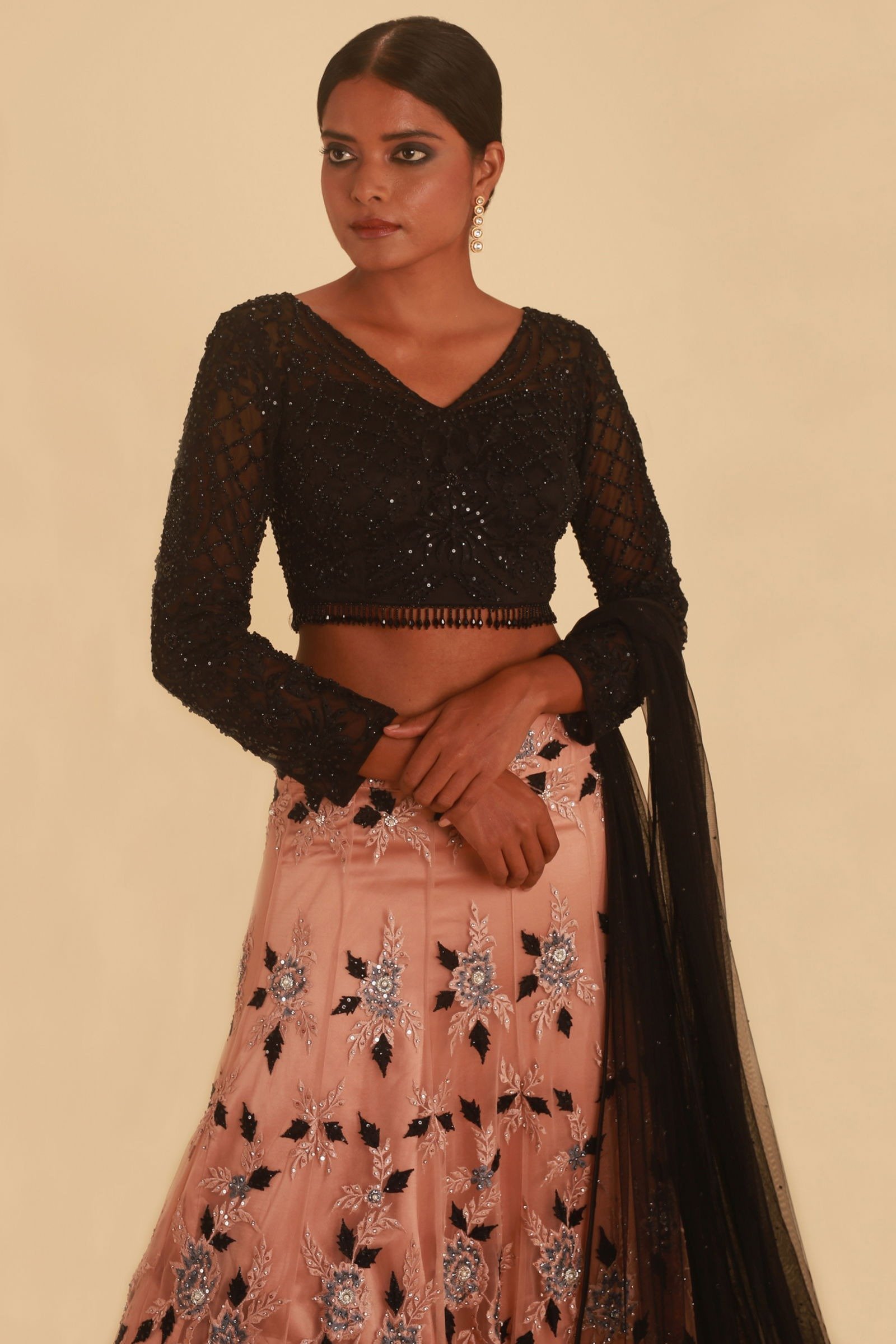 NUDE PINK LEHENGA WITH FLORAL DETAILS AND CONTRAST BLACK TASSELED CHOLI